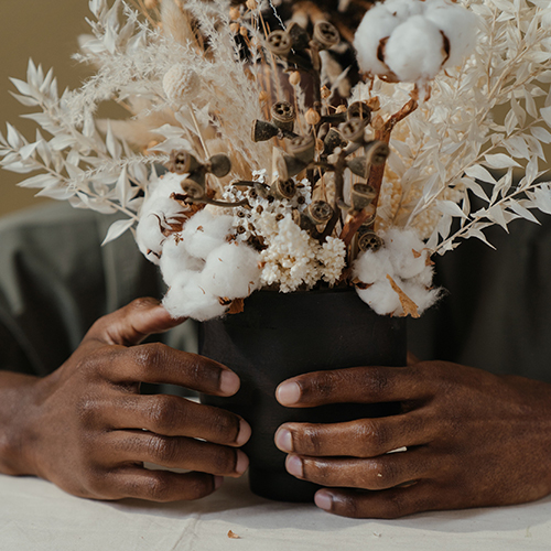 Hands holding a bunch of dried flowers